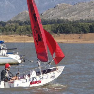 Topaz dinghy sailing with a red gennaker at Theewater